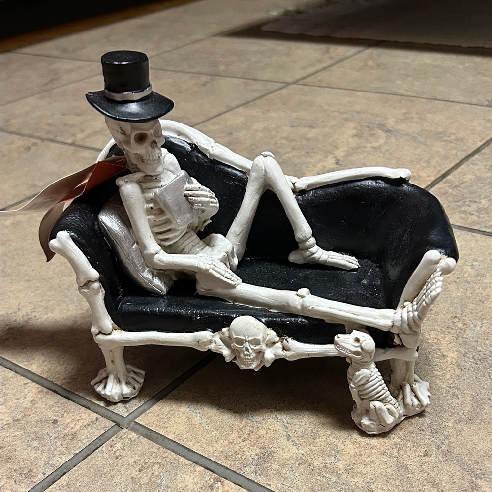 Skeleton Sculpture on Black Sofa